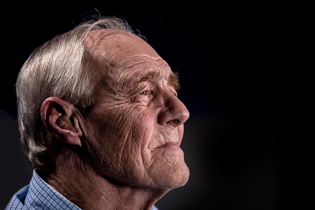 elderly man wearing hearing aids